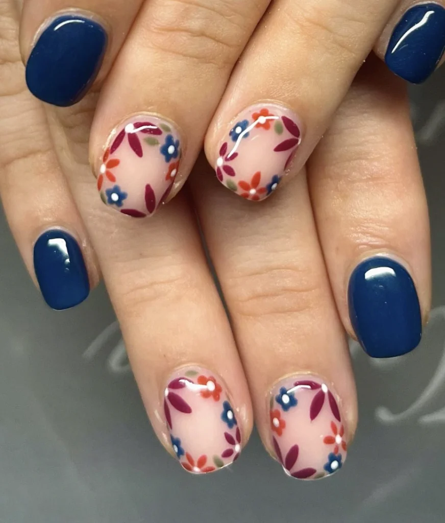 Navy Blue Squoval Nails with Delicate Floral Accents on Sheer Base