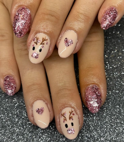Nude Oval Nails with Glitter Accents, Reindeer, and Heart Details