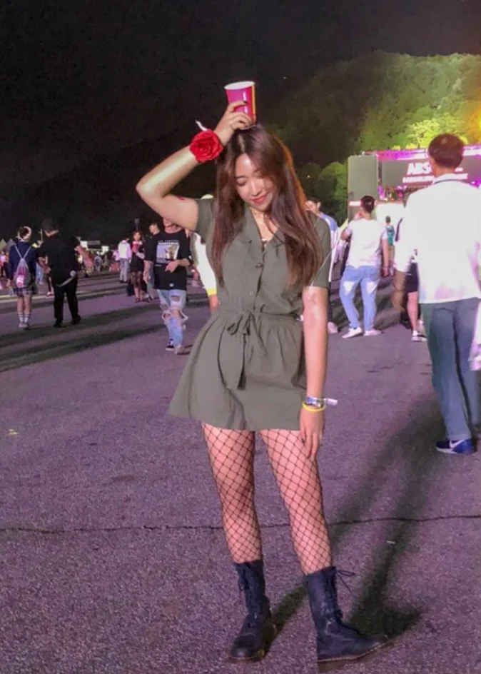 Olive Green Utility Romper + Black Fishnet Tights + Black Combat Boots + Red Scrunchie Wrist Accessory