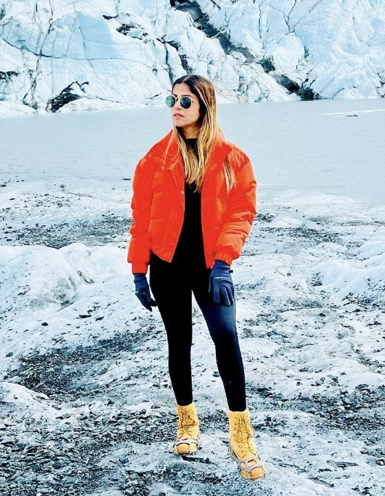 Orange Puffer Jacket + Black Leggings + Hiking Boots