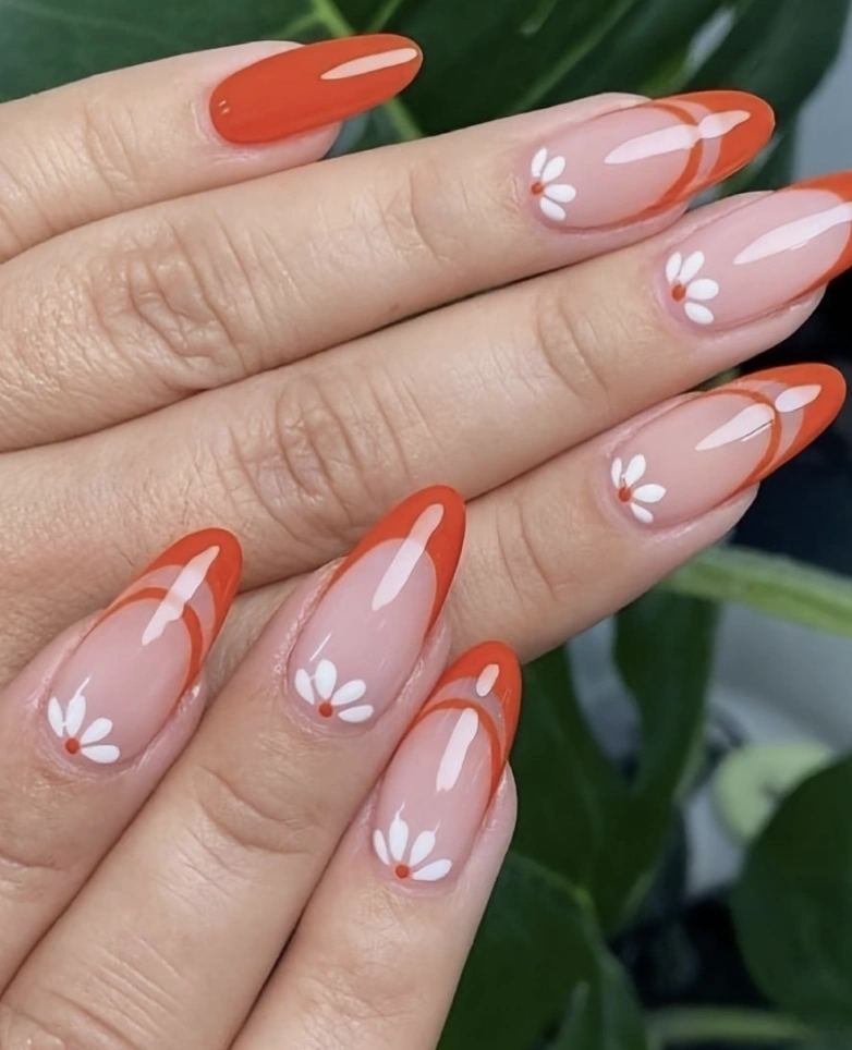 Orange-Tipped Almond Nails with Daisy Accents