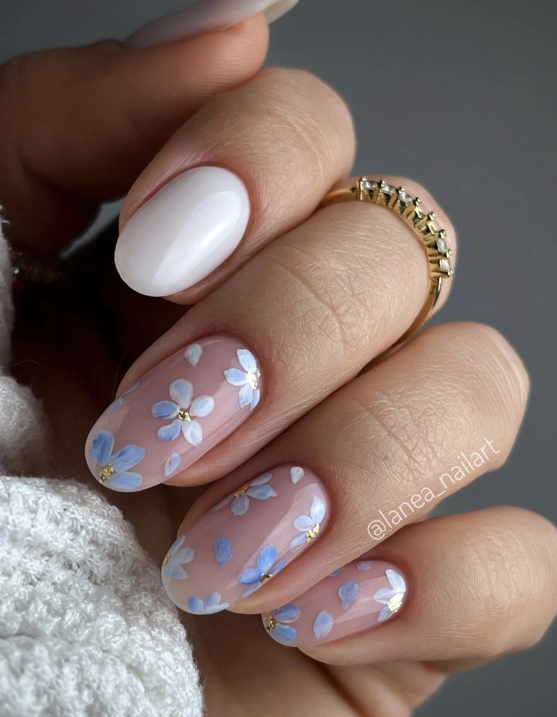 Oval Milky White Chrome Nails with Delicate Blue Floral Accents