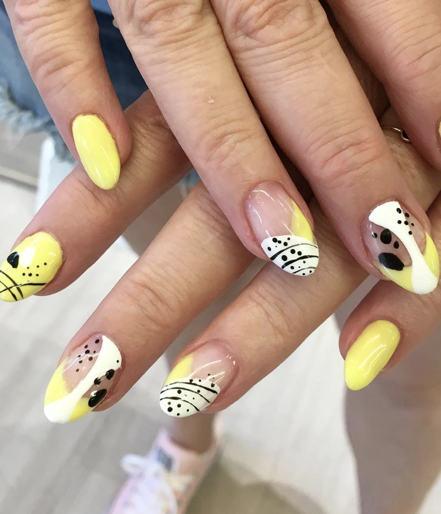 Pale Yellow Almond Nails with Black and White Accents