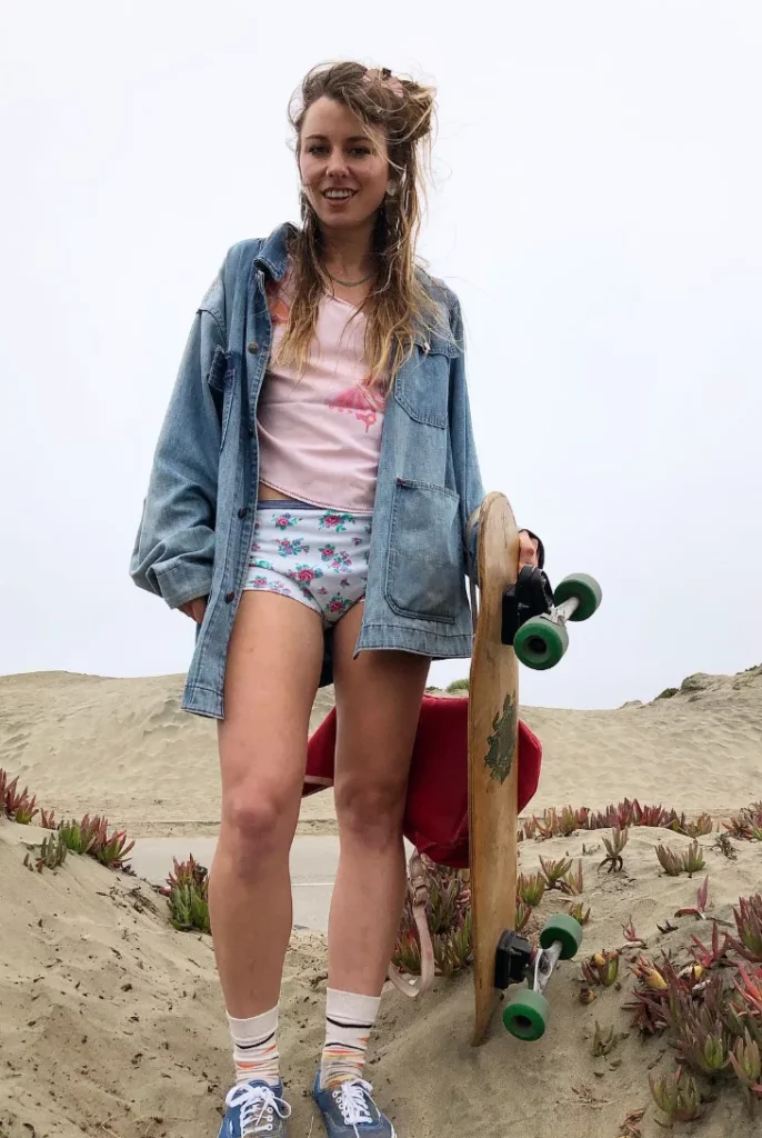 Pink Graphic Tee + Floral Micro Shorts + Oversized Denim Jacket + Sneakers
