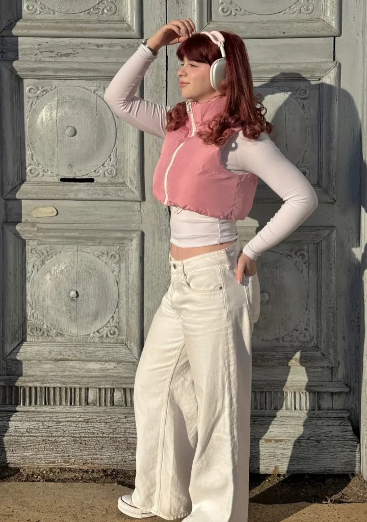Pink Puffer Vest + White Long-Sleeve Crop Top + White Wide-Leg Jeans + Headphones