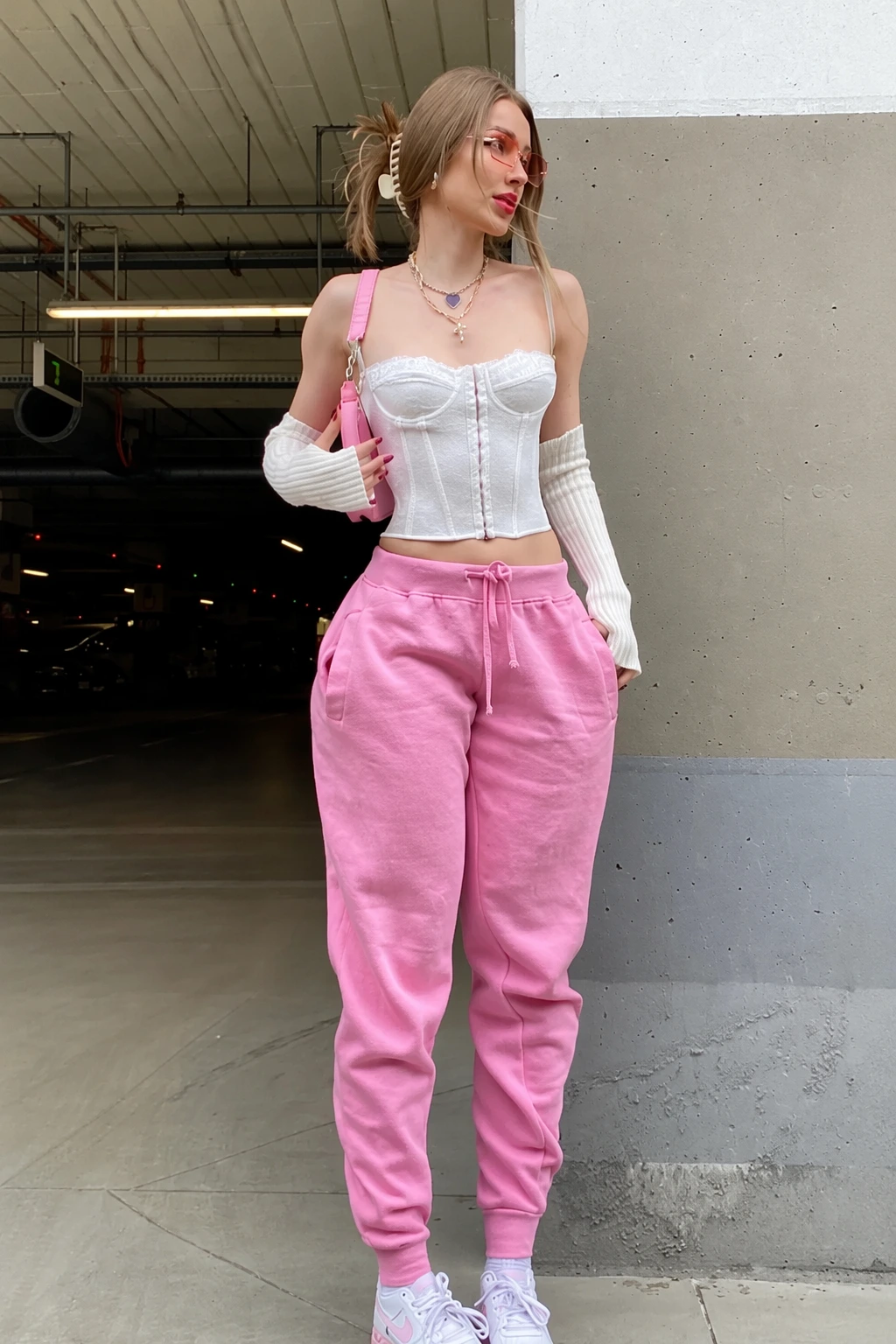 Pink Sweatpants + White Corset Top + White Knit Sleeves + Pink Handbag + White Sneakers
