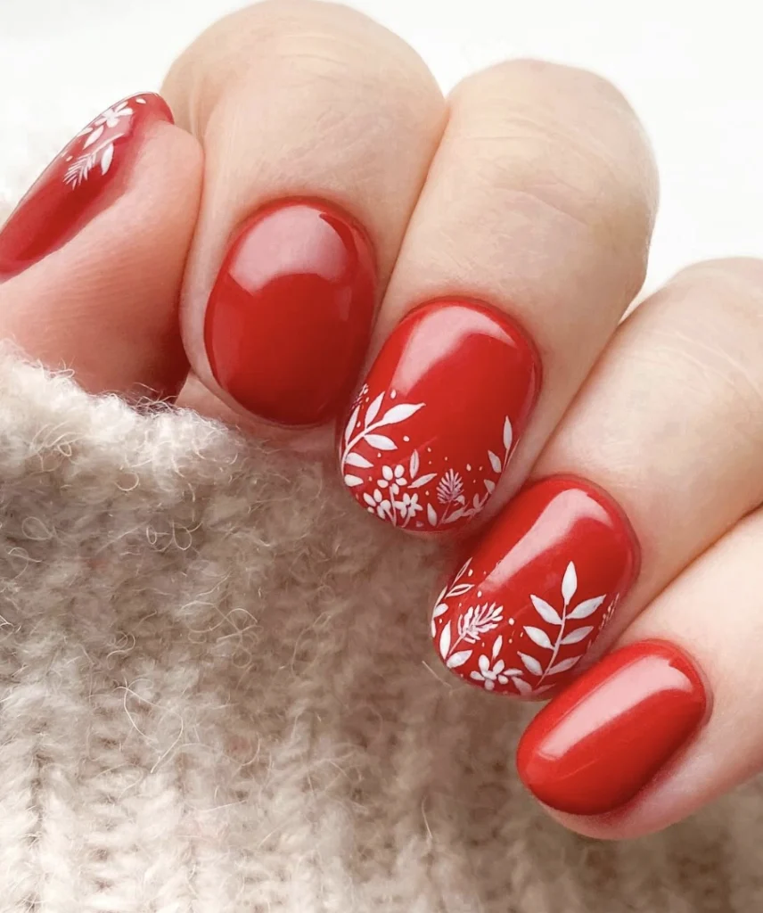 Red Rounded Nails with Delicate White Floral Accents