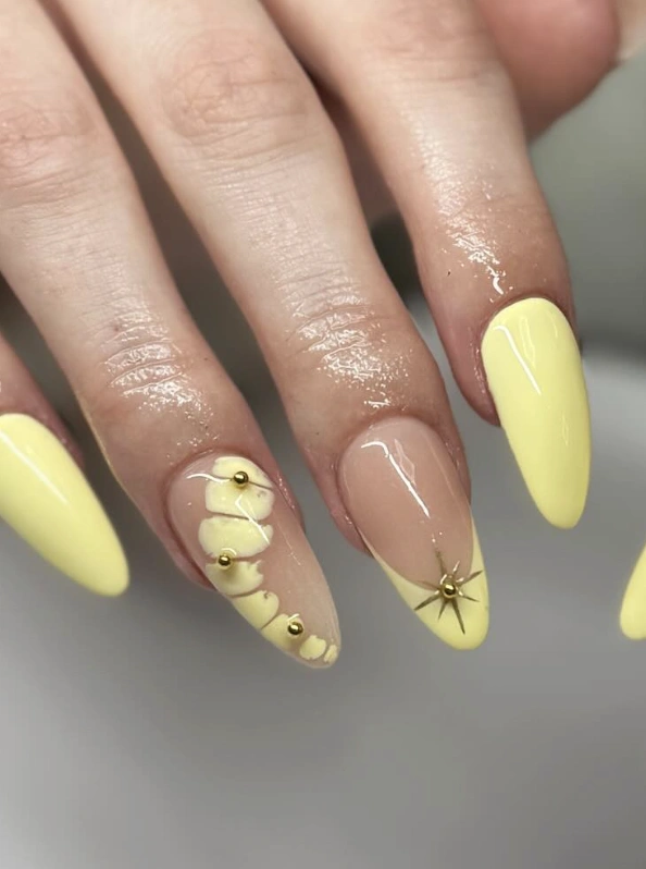 Sculpted Pastel Yellow Nails with Gold Embellishments