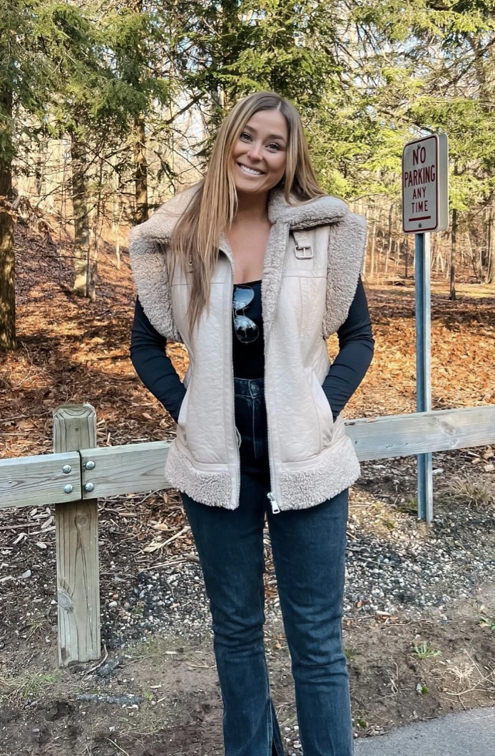 Shearling-Trimmed Vest + Black Fitted Top + Dark Wash Jeans