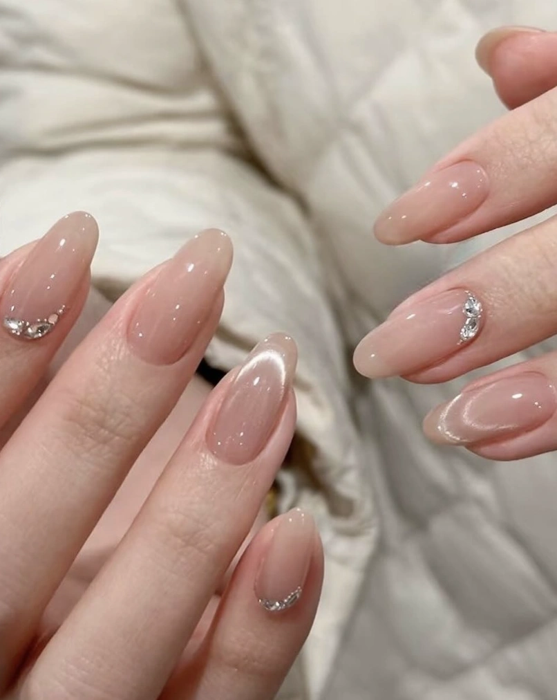 Sheer Almond Nails with Rhinestone Crescent Moon Detail