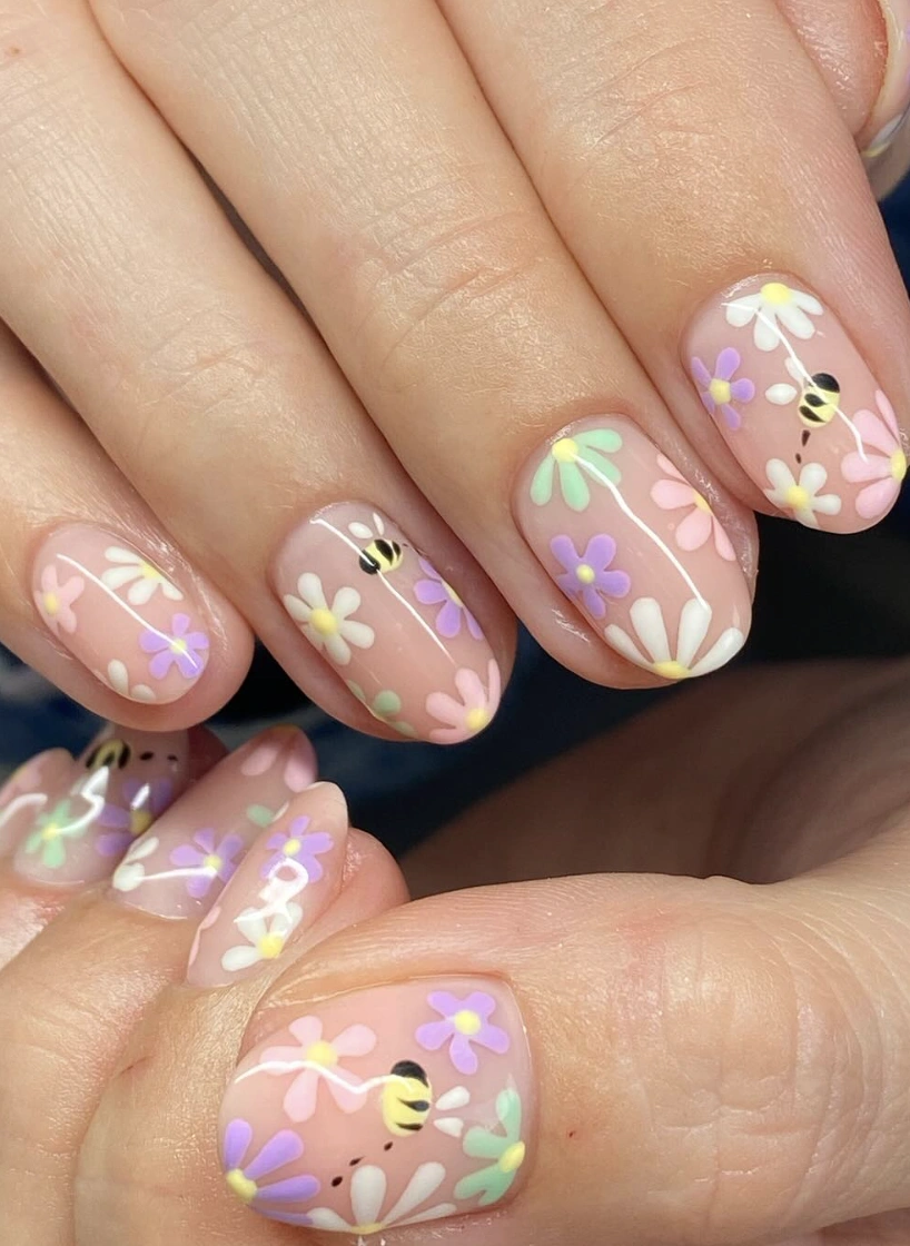 Sheer Oval Nails with Pastel Daisies and Bumble Bee Accent