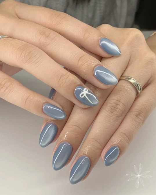 Shimmering Blue Almond Nails with Delicate White Accents