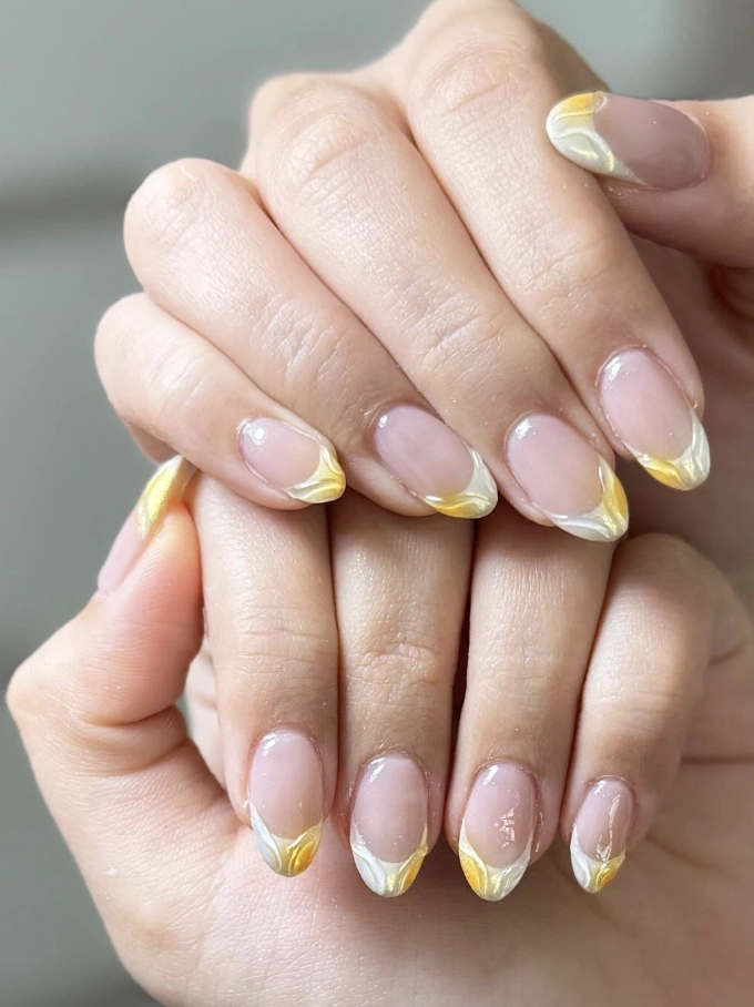 Shimmering Gold and White French Tip Oval Nails