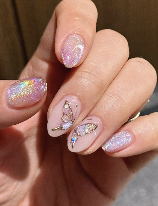Shimmering Nude Almond Nails with Gold-Lined Butterfly Details