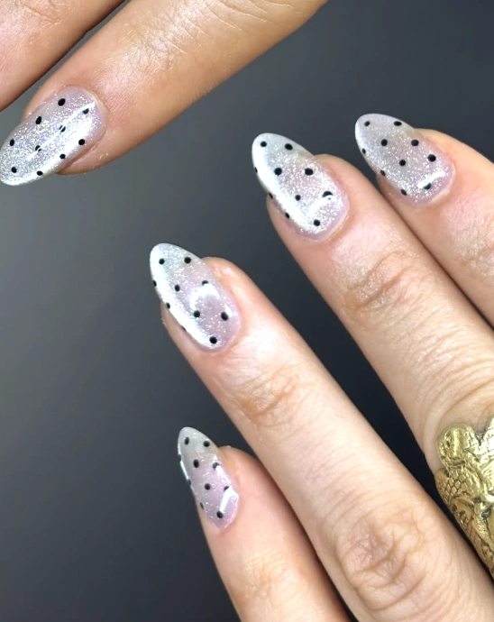 Shimmering Sheer Almond Nails with Black Polka Dots
