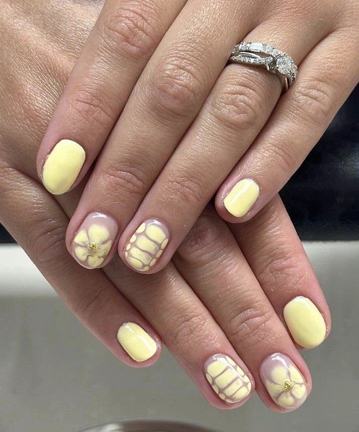 Short Oval Nails with Butter Yellow and Floral Accents