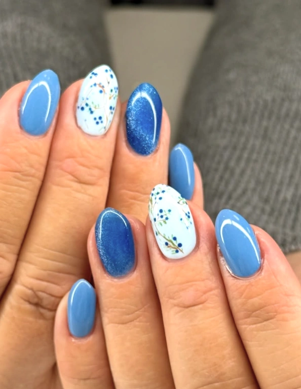 Sky Blue Almond Nails with Floral and Cat-Eye Accents