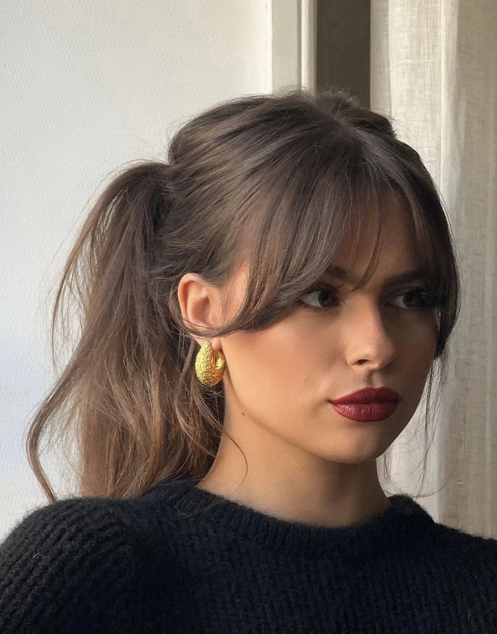 Soft Half-Up Ponytail for Medium Hair with Wispy Bangs