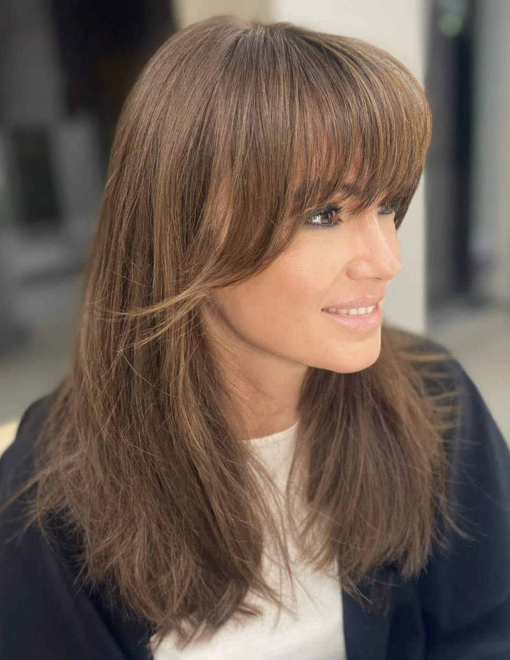 Soft Layered Blowout with Wispy Bangs for Medium Hair