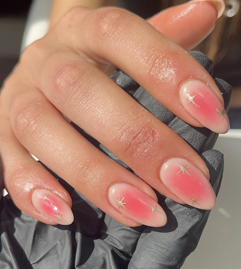 Soft Pink Ombre Almond Nails with Gold Stars