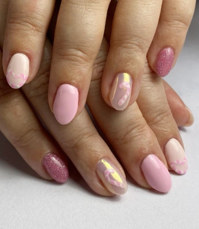 Soft Pink Oval Nails with Glitter Accent and Iridescent Candy Cane Detail
