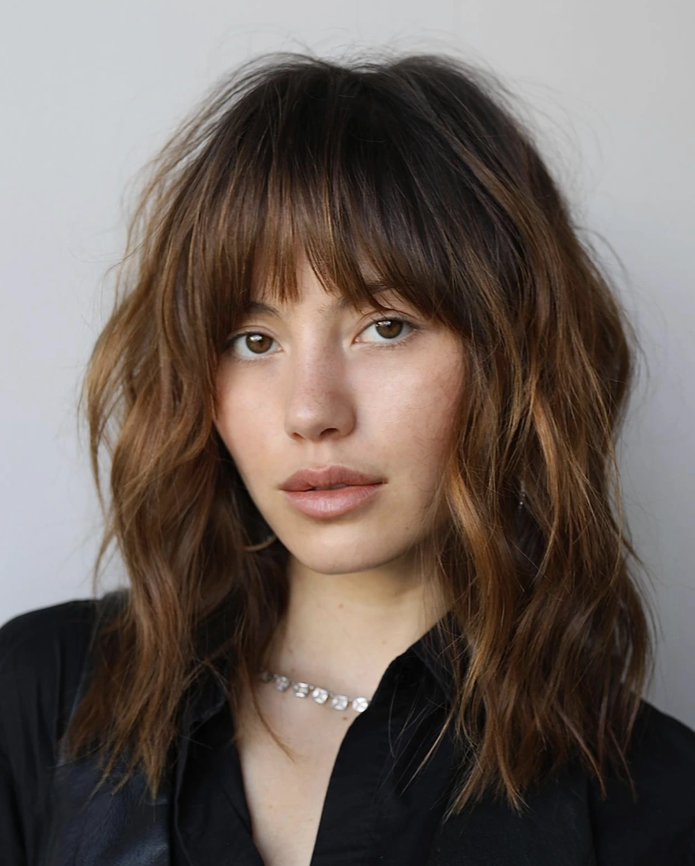 Soft Shag Haircut with Curtain Bangs and Lived-In Waves