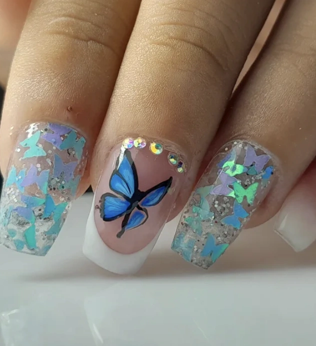Square Acrylic Nails with Blue Butterfly Accents and Iridescent Glitter