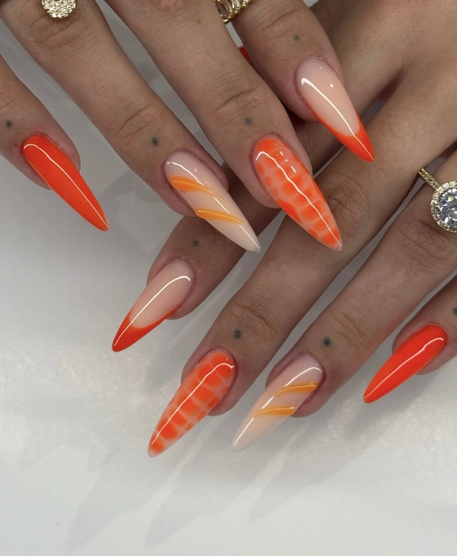 Stiletto Nails with Orange Ombre and Abstract Accents