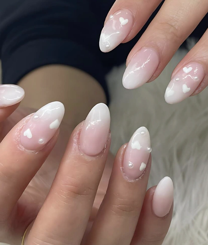 Subtle Ombre Almond Nails with Pearl and Heart Accents