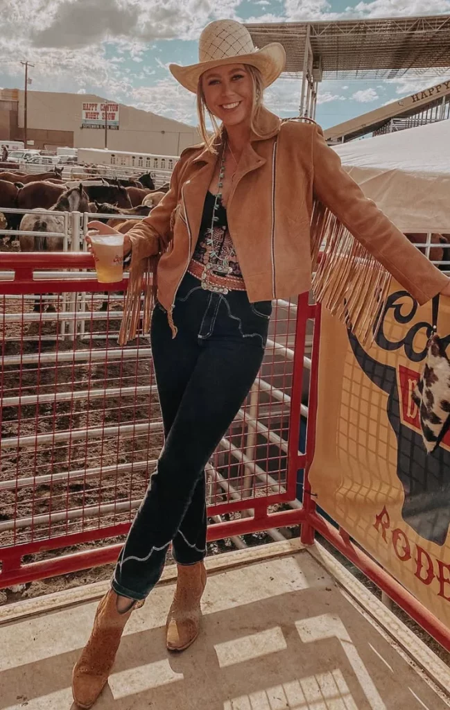 Tan Suede Jacket + Black Graphic Tank Top + Dark Skinny Jeans + Tan Western Boots + White Cowboy Hat