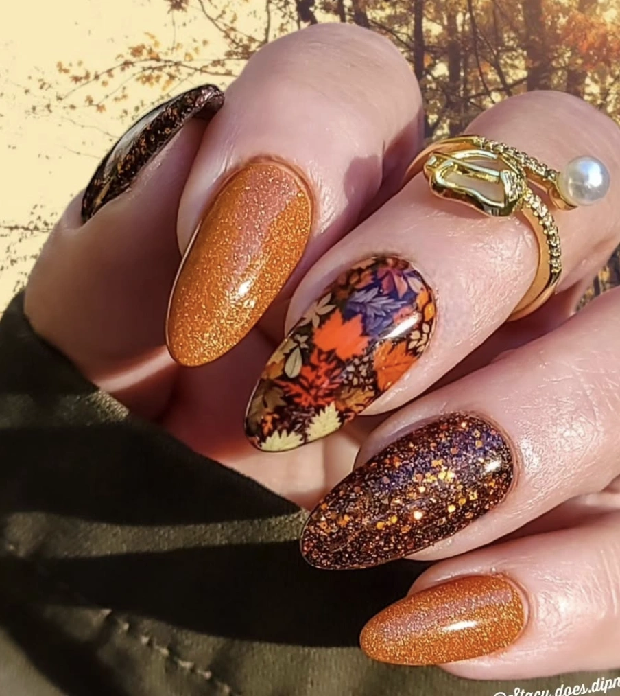 Vibrant Autumn-Inspired Almond Nails with Glitter and Leaf Patterns
