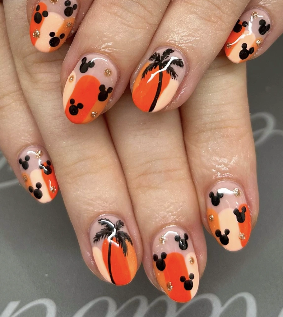Vibrant Ombre Nails with Mickey Mouse Accents and Glittering Gold Dots