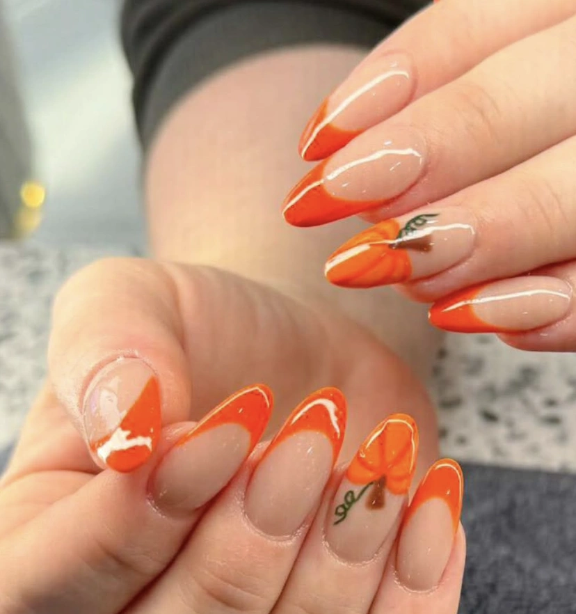 Vibrant Pumpkin-Inspired Fall Almond Nails with Glossy Orange Tips and Whimsical Leaf Accents