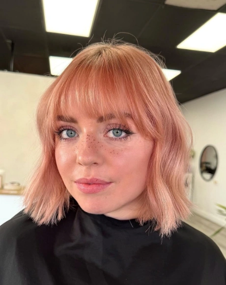 Wavy Bob with Blunt Bangs and Rose Gold Balayage