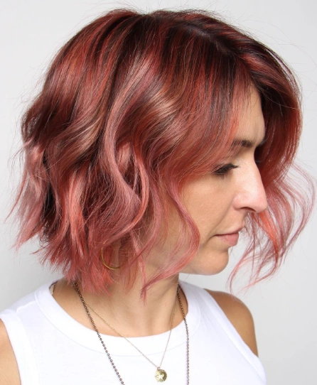 Wavy Bob with Rose Gold Balayage and Side-Swept Fringe