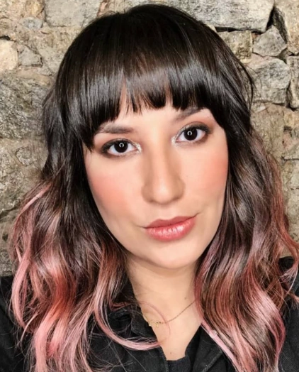 Wavy Brunette Bob with Blunt Bangs and Rosegold Haircolor Highlights
