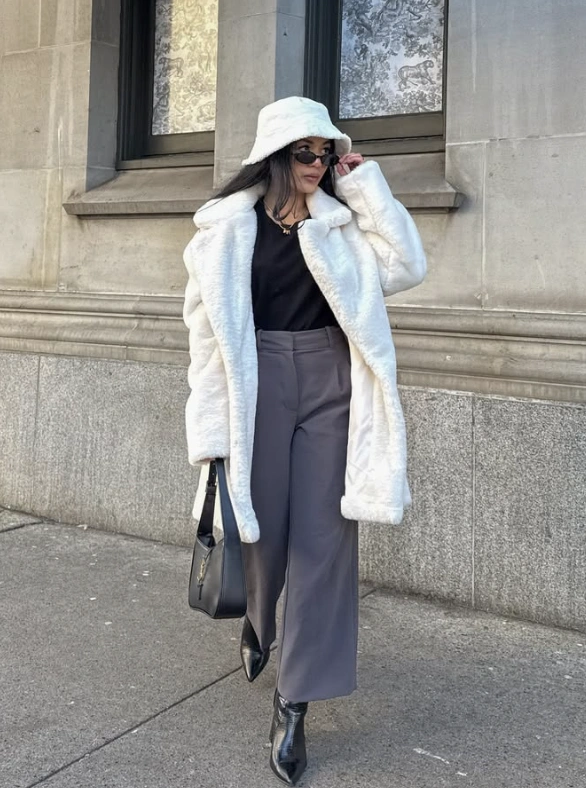 White Bucket Hat + Black Top + Gray Wide-Leg Pants + White Faux Fur Coat + Black Pointed-Toe Ankle Boots