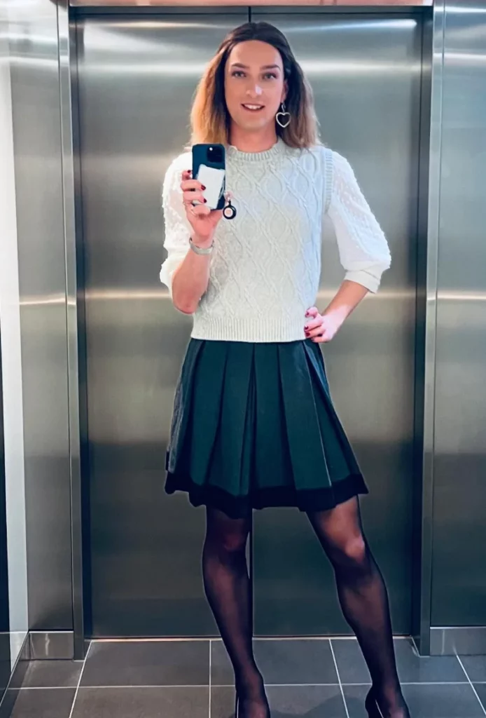 White Cable-Knit Sweater + Dark Pleated Skirt + Black Sheer Tights