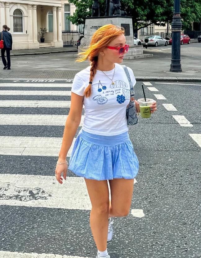 White Graphic Tee + Blue Pleated Mini Skirt + White Sneakers