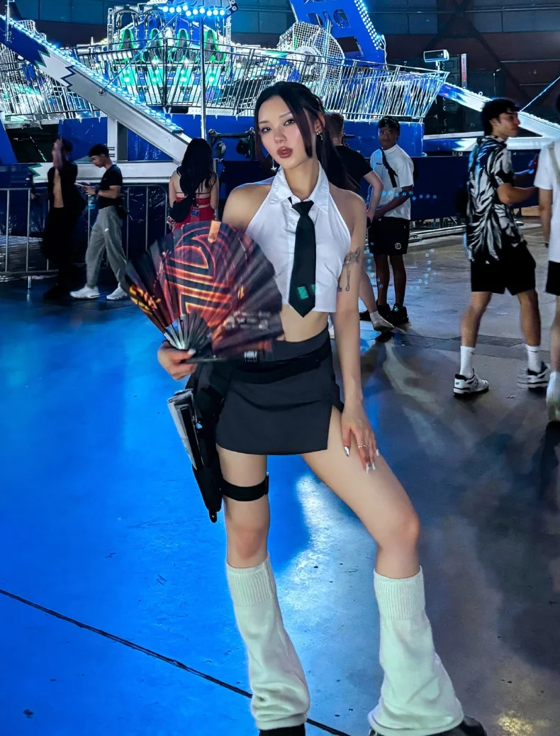 White Sleeveless Button-Up Crop Top + Black Mini Skirt + Black Neck Tie + White Knit Leg Warmers + Black Shoes