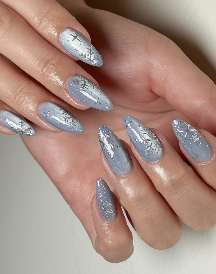 Winter Wonderland: Light Blue Almond Nails with Silver Snowflakes