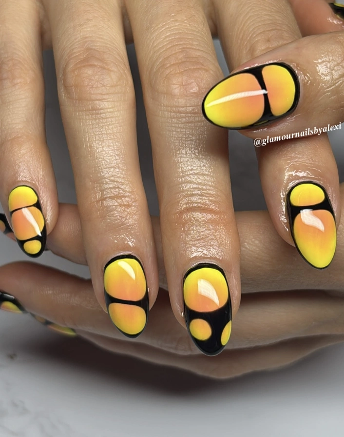 Yellow and Orange Gradient Nails with Black Bubble Accents